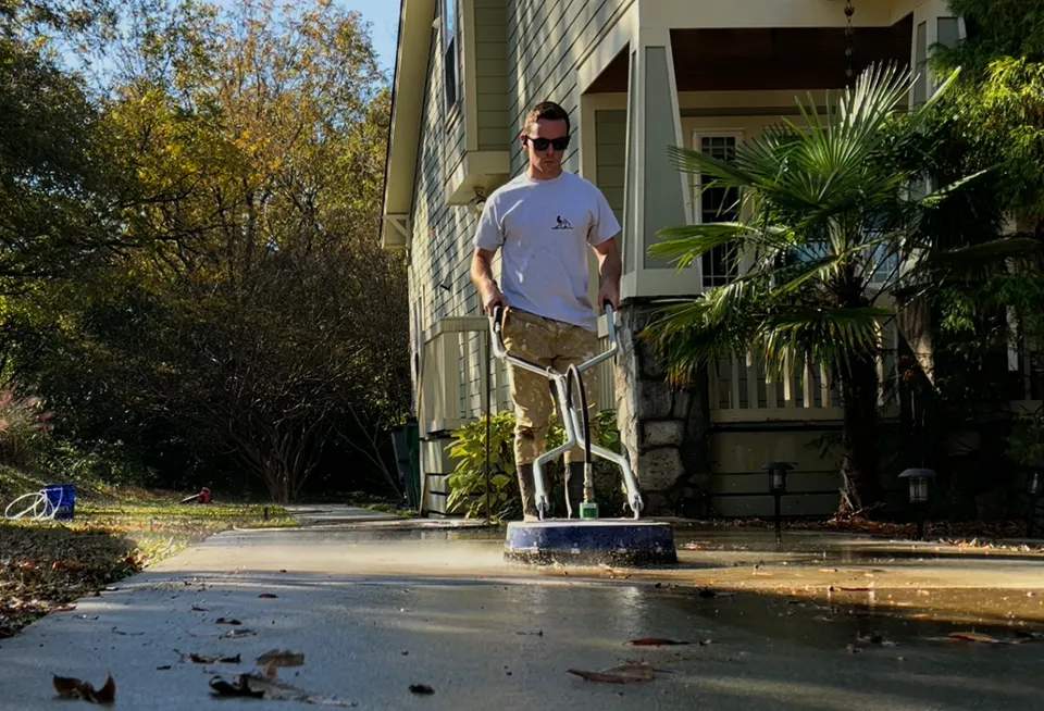 Rooster Property Care team member pressure washing in Charlotte