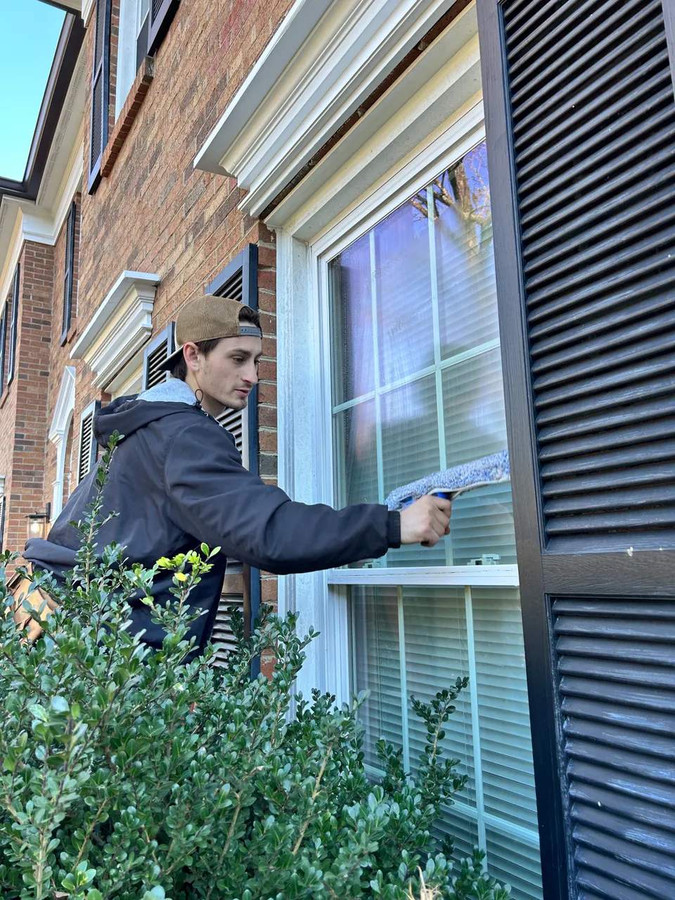 Window cleaning with a squeegee in Charlotte