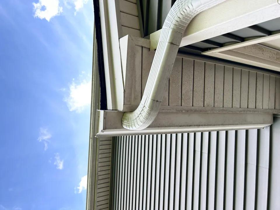 Water overflowing from a clogged gutter causing foundation erosion