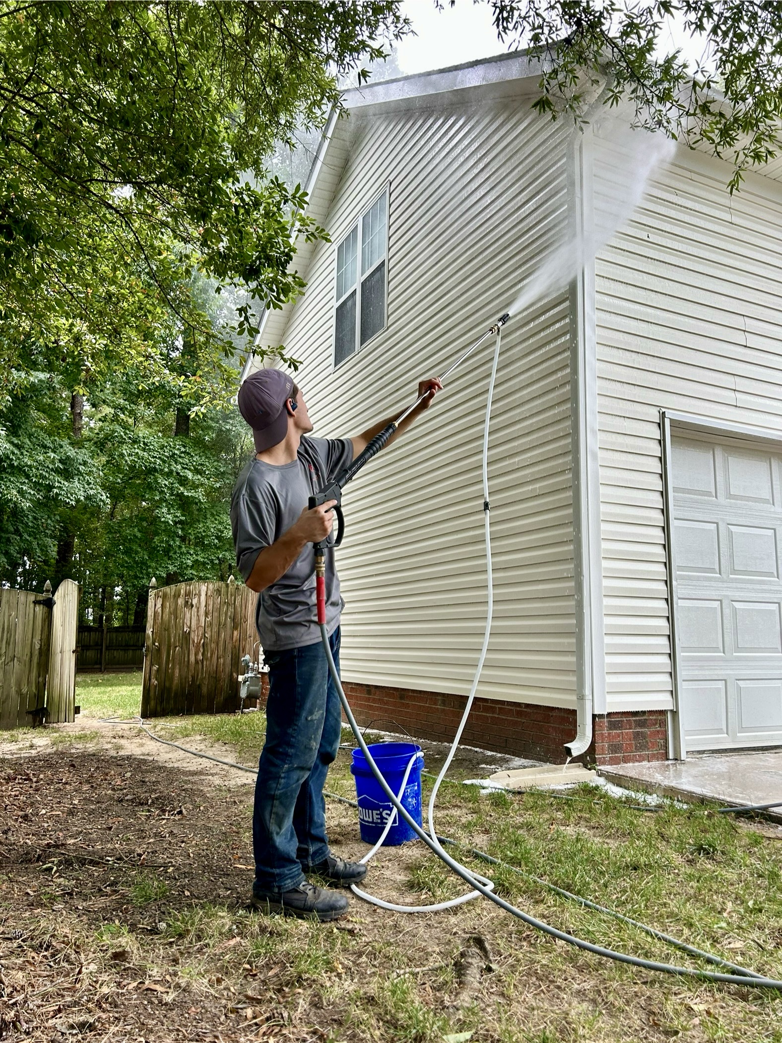 Soft wash solution being applied to siding in Charlotte