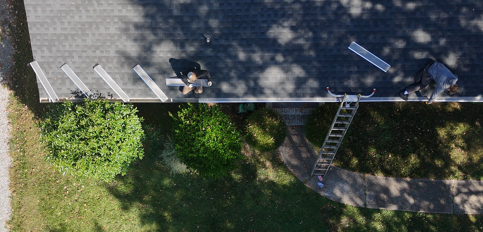 Stainless steel micro-mesh gutter guard installation on a Charlotte home